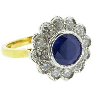 A Round Sapphire and Diamond Cluster Ring - Click Image to Close