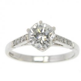 A Brilliant Cut diamond engagement ring, diamond set shoulders