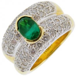An Oval Emerald and Pave Diamond Dress Ring.