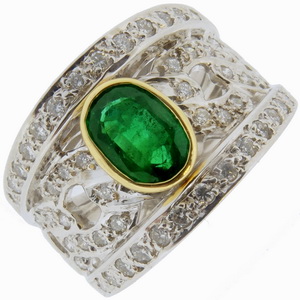 An Oval Emerald and Diamond Dress Ring. - Click Image to Close