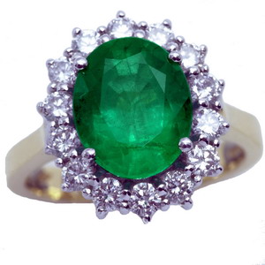 An Oval Emerald and diamond cluster ring - Click Image to Close